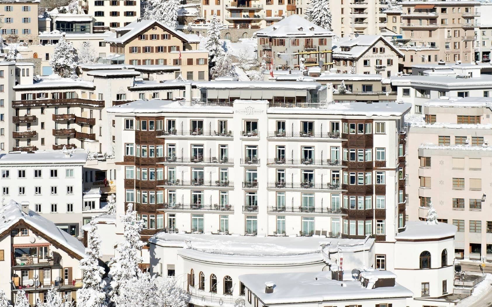 Hotel exterior with private balconies and mountain village setting