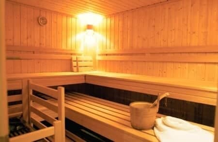 Private cedar sauna with tiered seating and water bucket