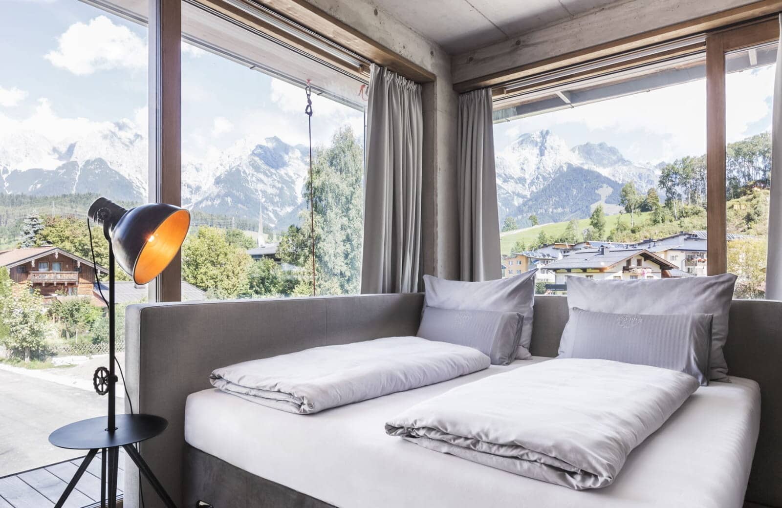 Guest bedroom with king bed and panoramic Alpine mountain views
