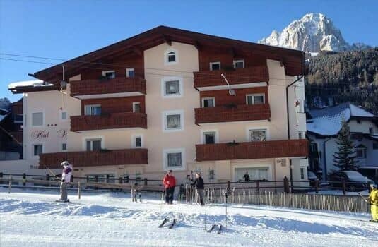 Ski-in/ski-out chalet exterior with private balconies and mountain backdrop