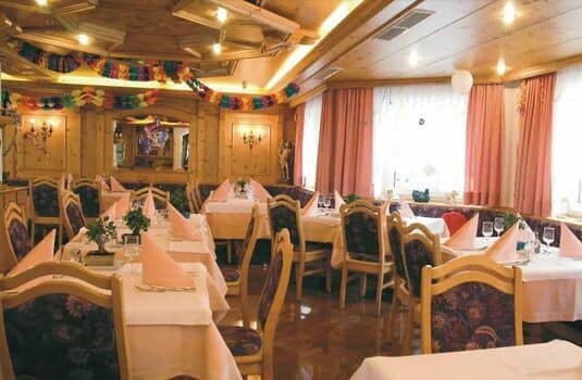 Dining room with wood-paneled ceiling and banquet seating for large groups