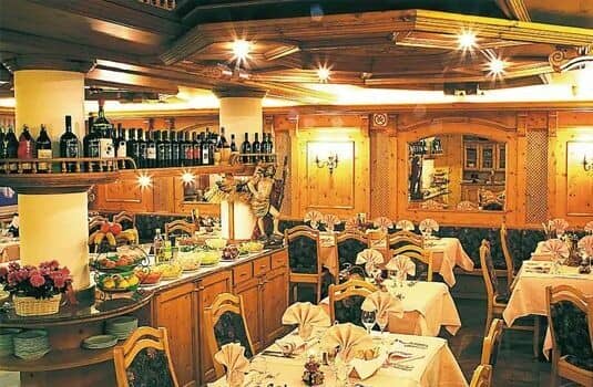 Wine bar and dining room with pine paneling and buffet station