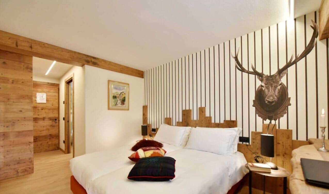 Guest bedroom with two twin beds pushed together and ensuite access