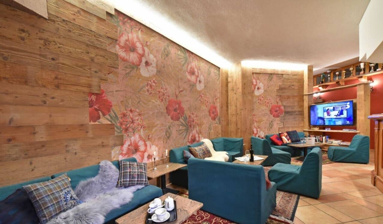 Lounge area with modular seating, reclaimed wood accents, and floral wall mural