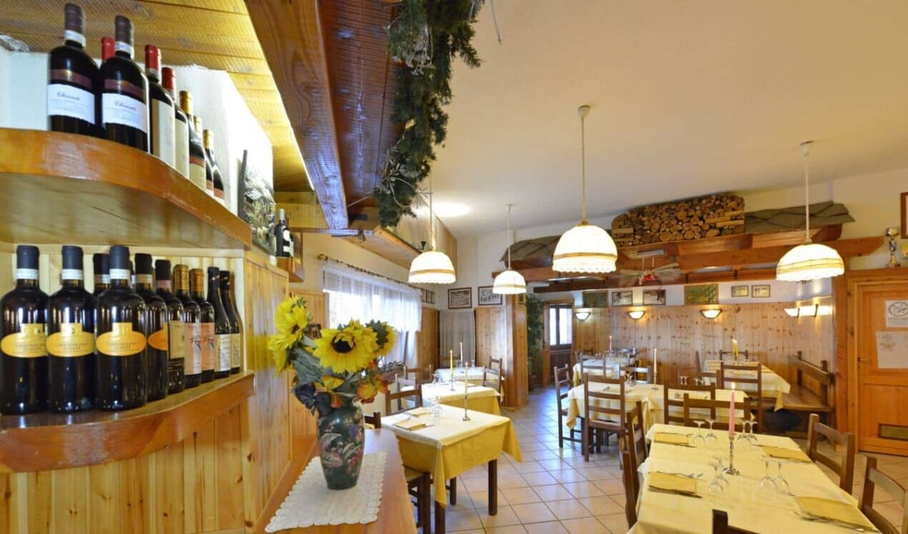 Dining room with wood paneling and wine storage shelving