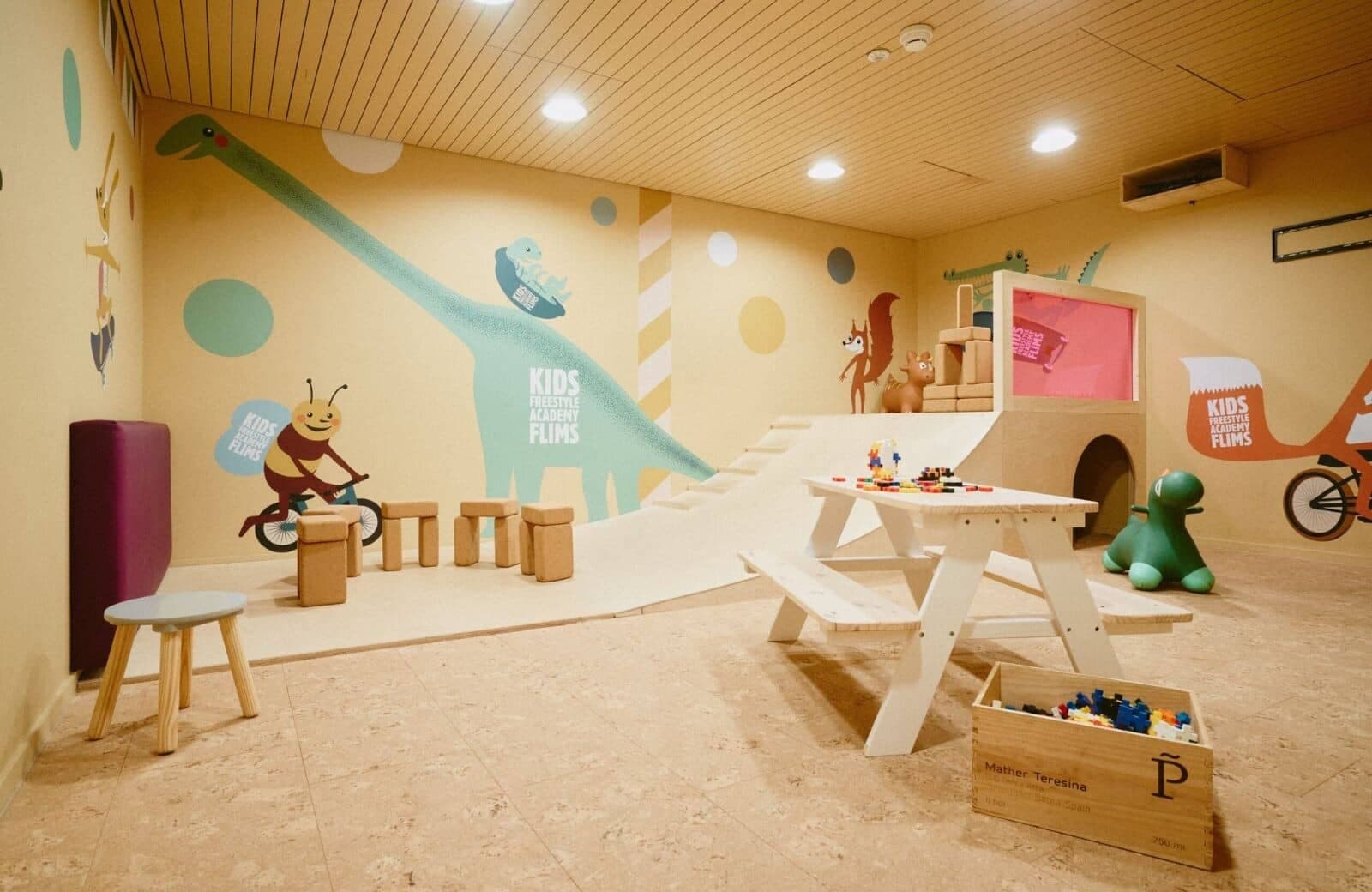 Kids' playroom with indoor climbing ramp and activity table