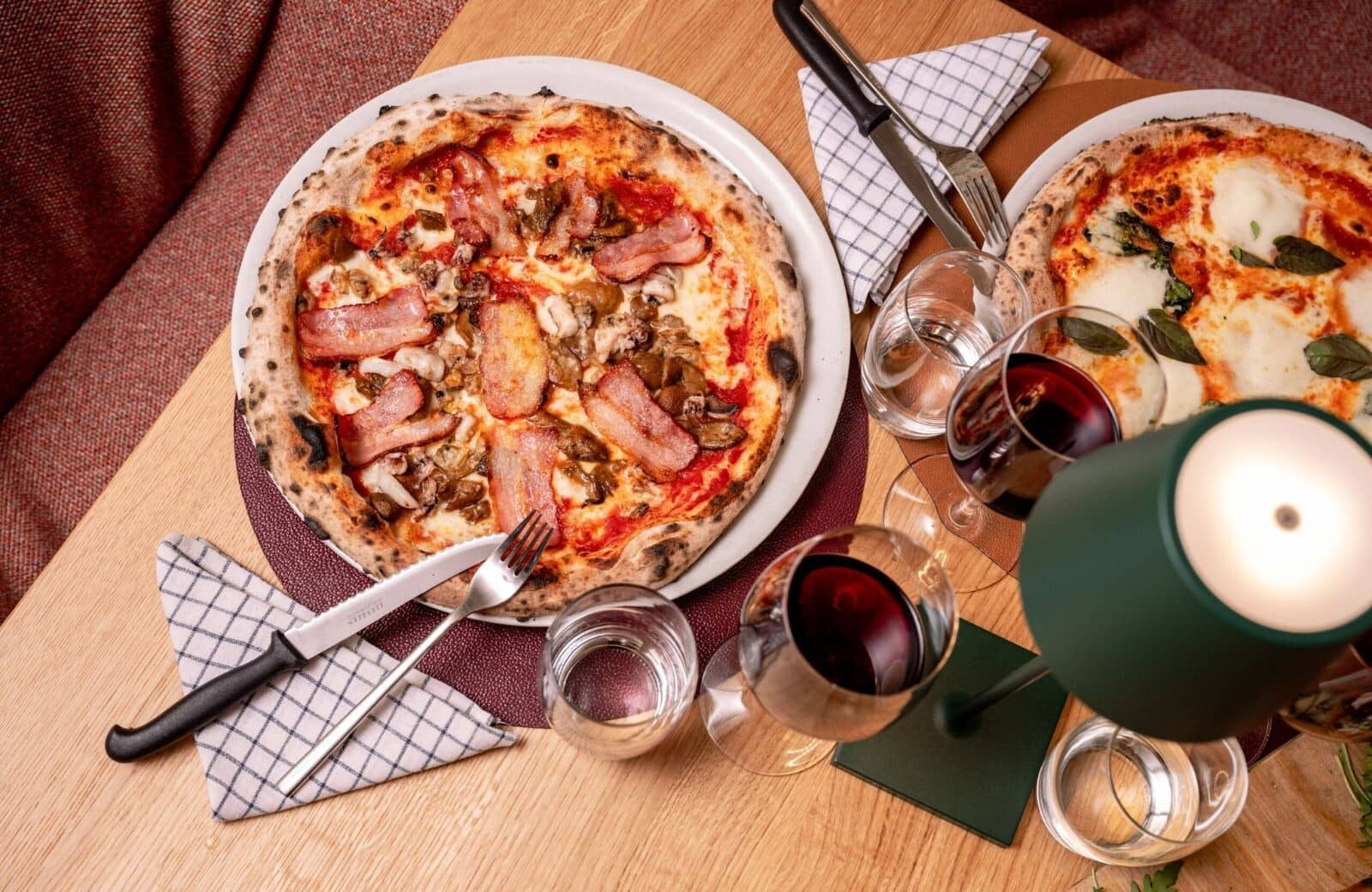 Dining setup with wood-fired pizza and red wine pairings