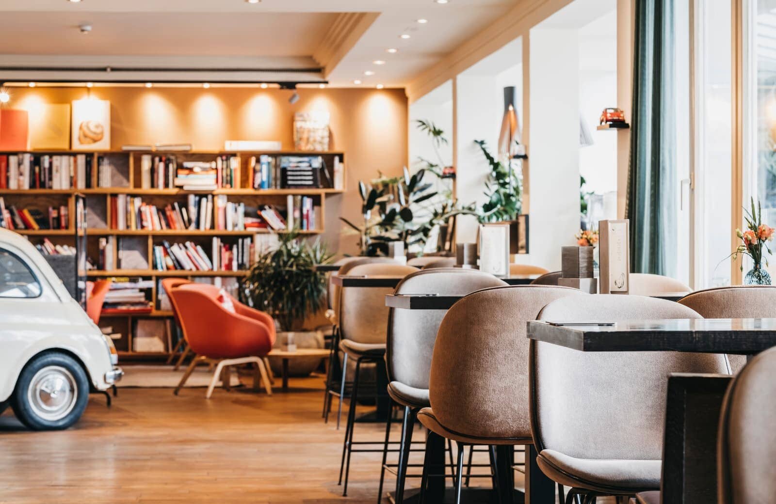 Library lounge with bar-height seating and floor-to-ceiling windows