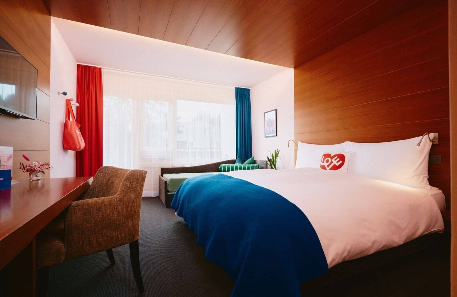 King bedroom with desk workspace and window-side daybed