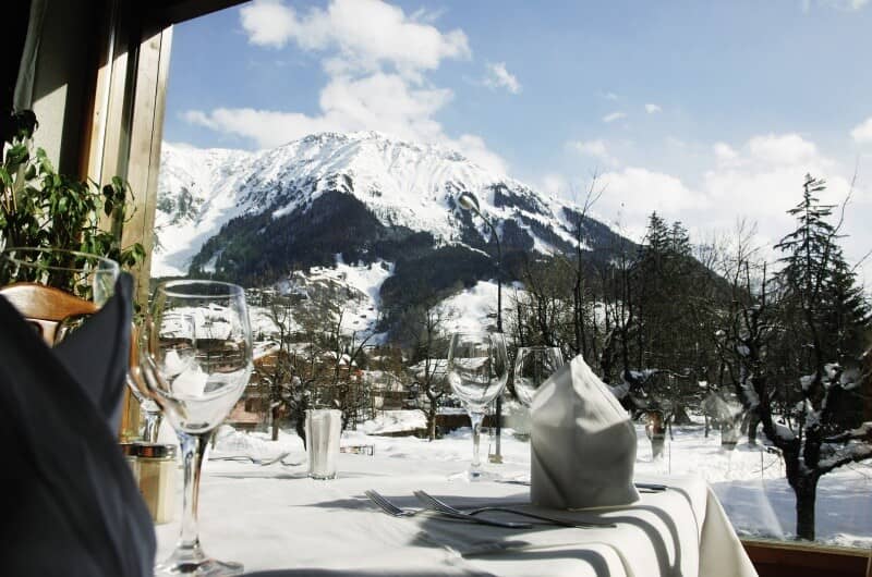 Dining table with panoramic views of snow-capped mountains