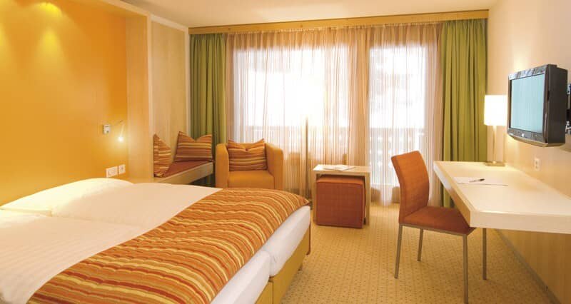 Bedroom with king bed, dedicated work desk, and window reading nook