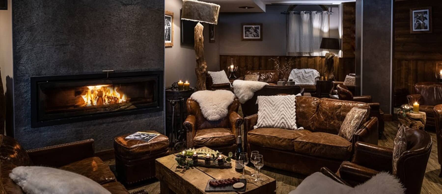 Lounge area with linear wood-burning fireplace and leather club seating