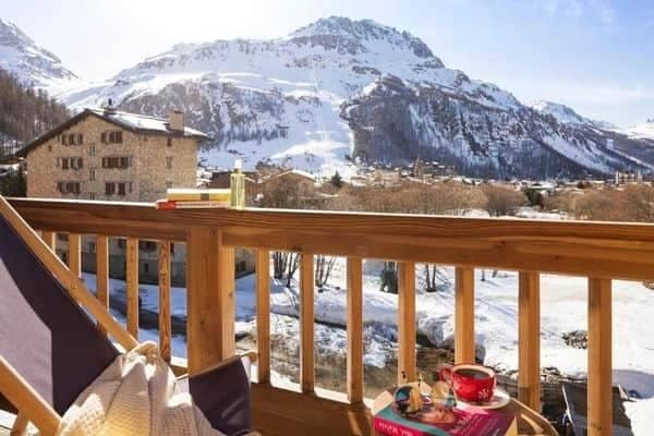 Private balcony with lounge seating and panoramic mountain views