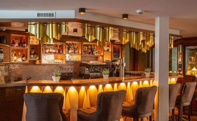 Private bar with professional espresso machine and seating for 5