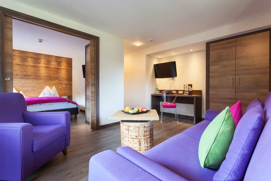 Living area with dedicated workspace and sliding doors to bedroom