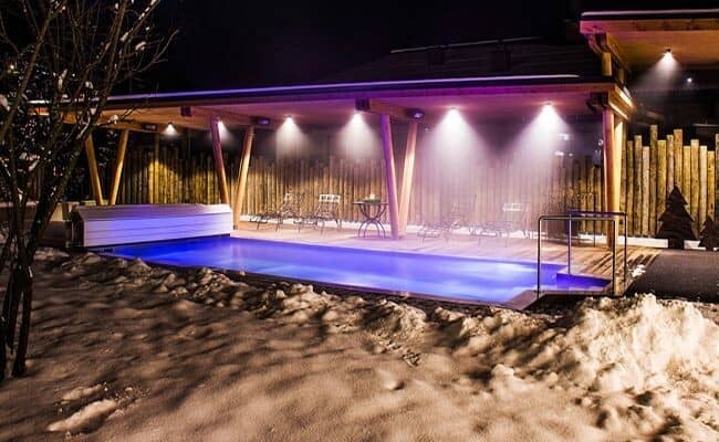 Heated outdoor pool and covered patio with lounge seating