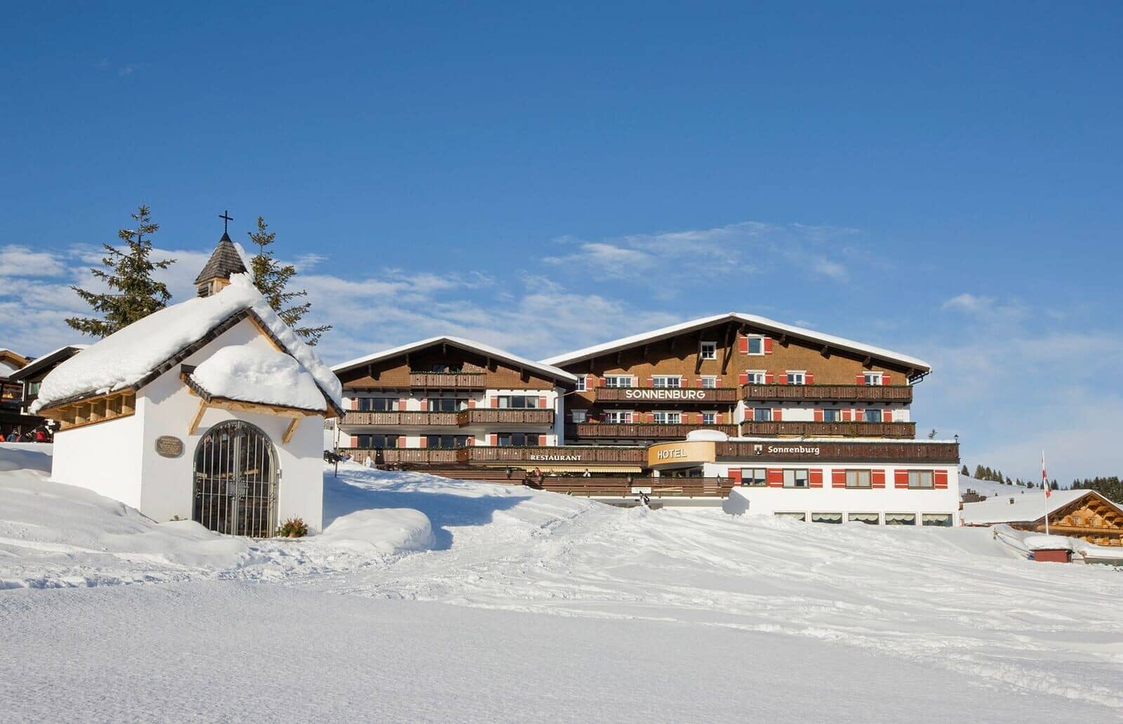 Ski-in, ski-out hotel exterior with private balconies and mountain views