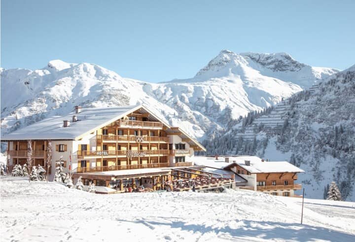 Ski-in/ski-out hotel exterior with mountainside terrace and private balconies