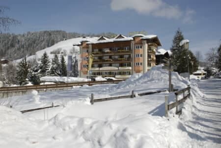 Lodge exterior featuring private balconies and views of snow-covered slopes