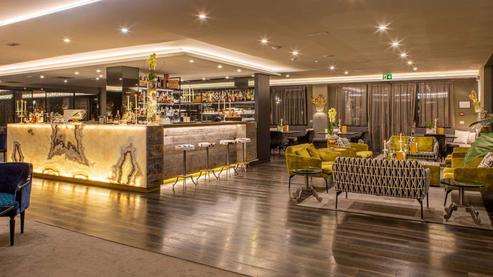 Lounge bar with backlit onyx counter and velvet seating areas