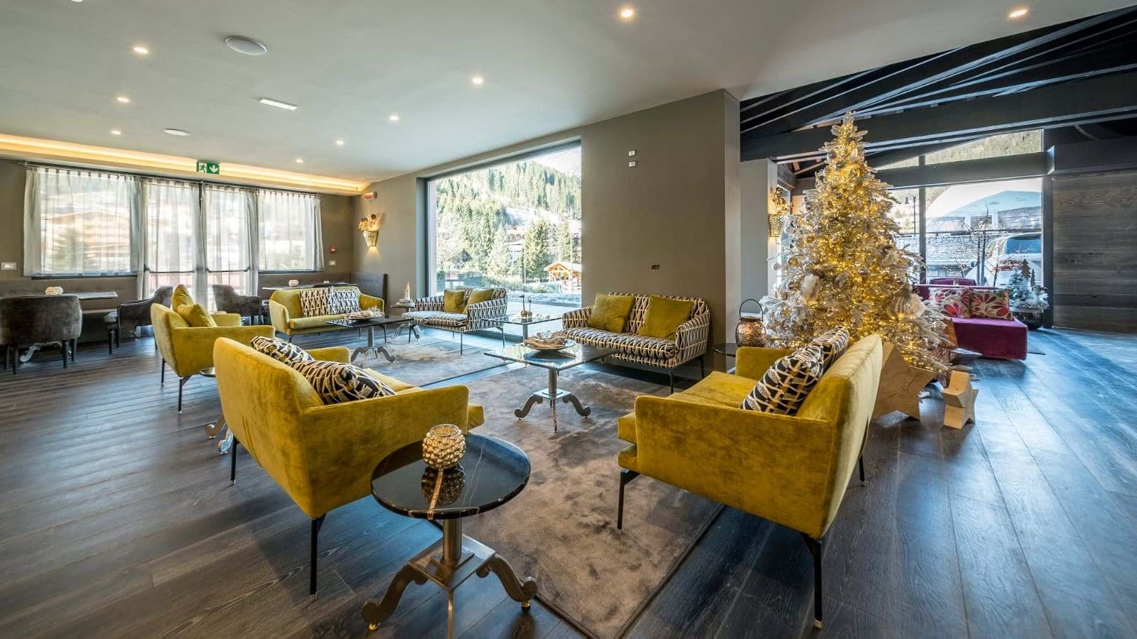 Shared lounge area with multiple sofa groupings and mountain views