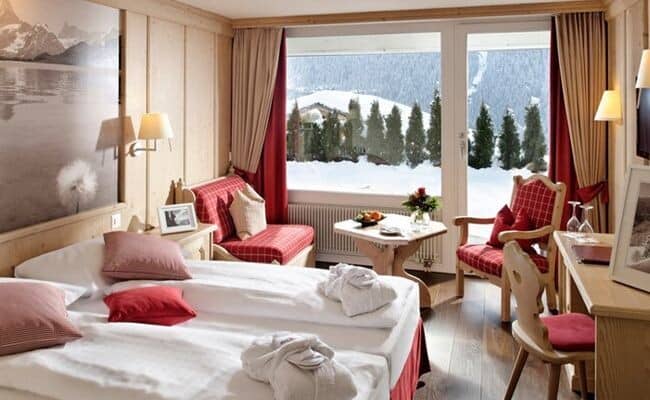 Bedroom with king bed, seating area, and terrace access to mountain views