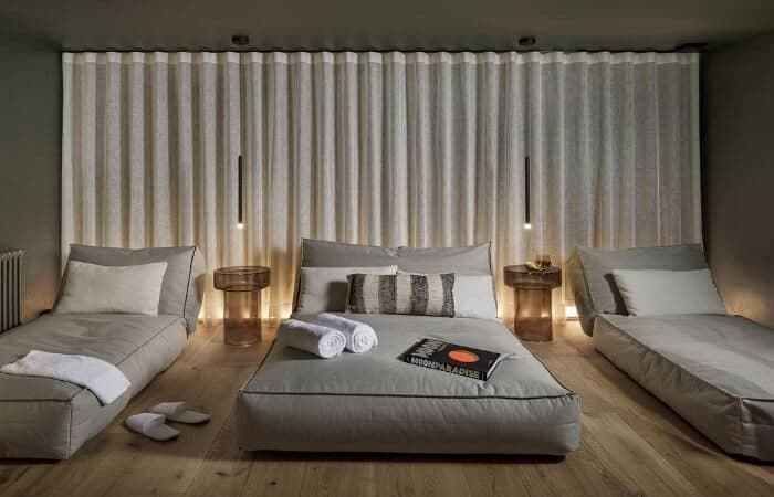 Media room with floor-cushion seating and blackout curtains