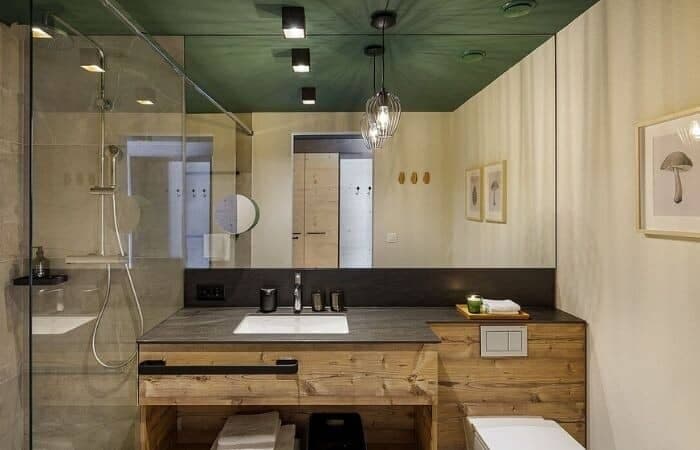 Bathroom featuring walk-in glass shower and wood vanity with stone countertop