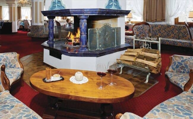 Lounge area with 360-degree wood-burning fireplace and tile accents