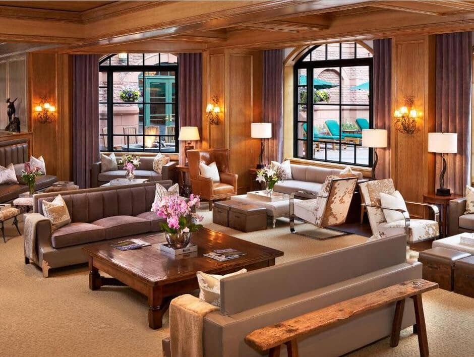 Shared lounge area with wood-paneled walls and views of the pool deck
