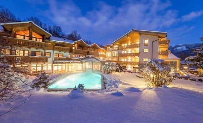 Ski resort exterior with heated outdoor pool and private balconies