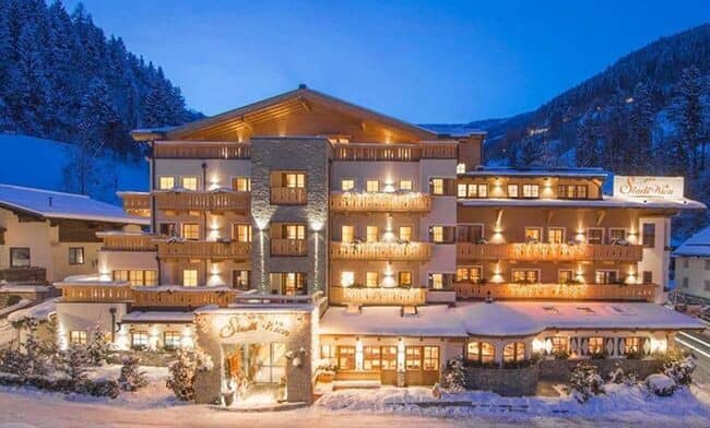 Ski-in chalet exterior with private balconies and mountain views