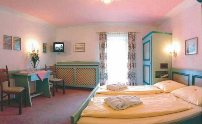 Guest bedroom with two twin beds and dedicated workspace