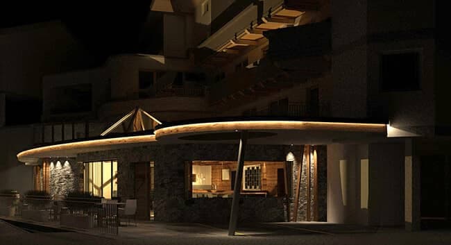 Stone exterior with illuminated terrace and outdoor seating