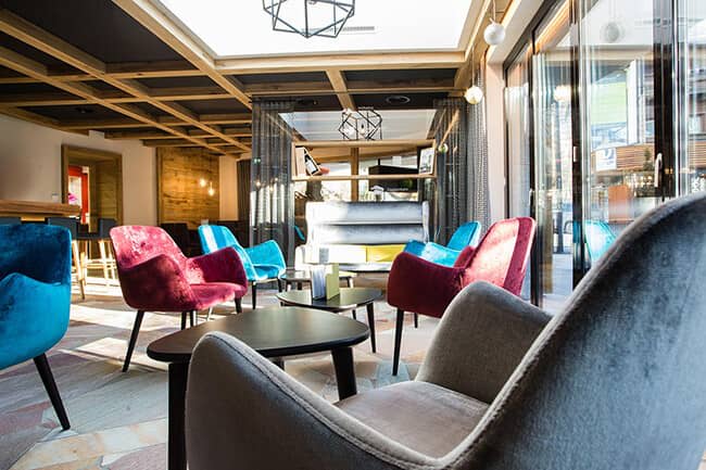 Lounge area with skylight and floor-to-ceiling glass doors