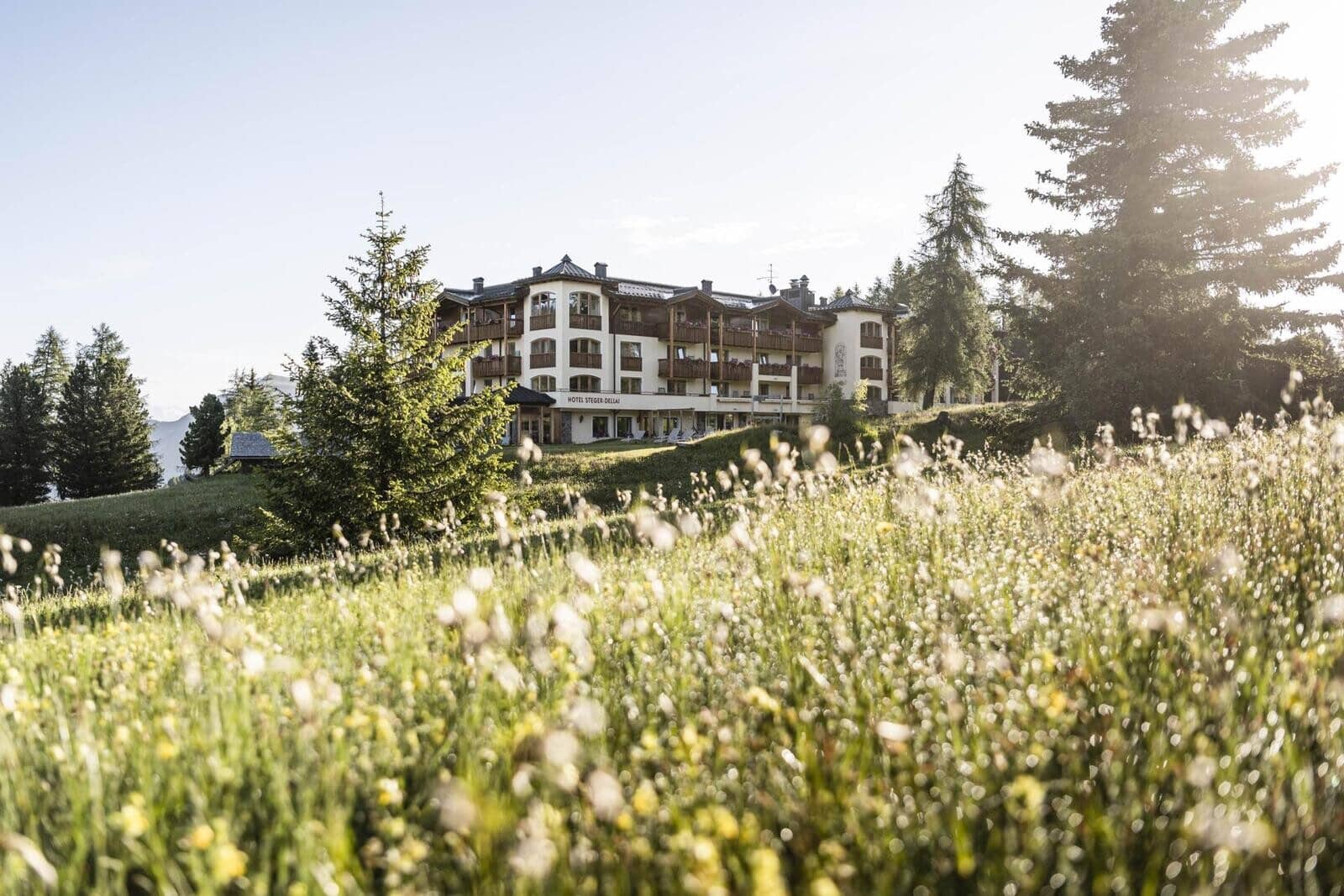 Hotel exterior with private balconies and wildflower meadow frontage