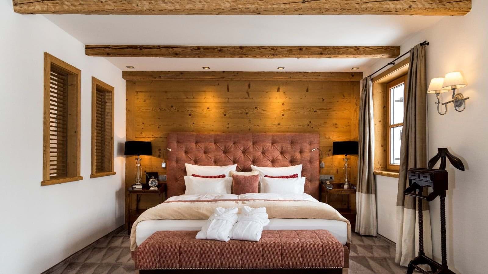Guest bedroom with king bed and reclaimed timber ceiling beams