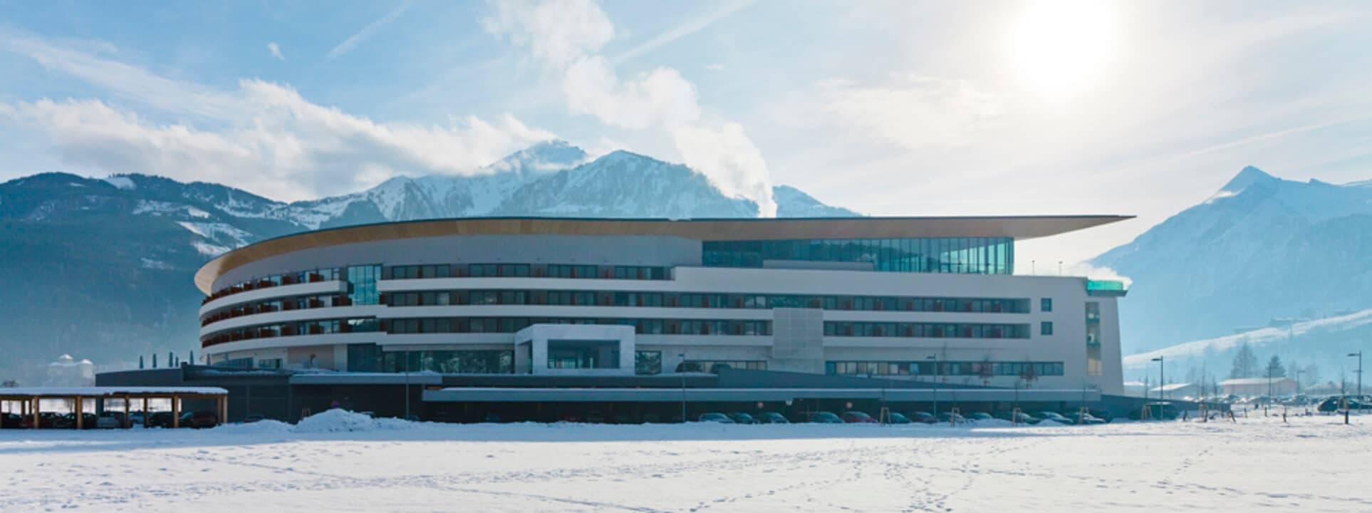 Building exterior with private balconies and mountain backdrop