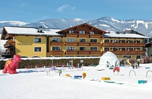 Resort exterior with on-site children's winter playground and igloo