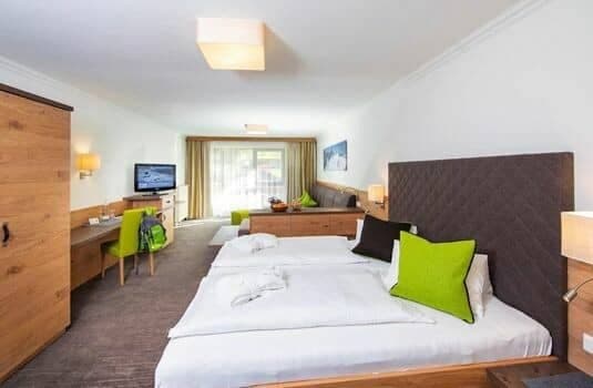 Bedroom suite with king bed, dedicated workspace, and sofa seating