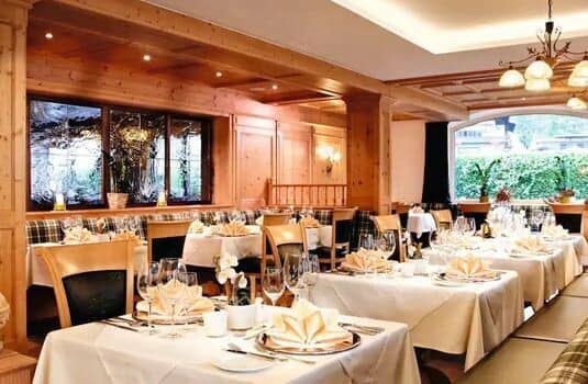 Dining room with traditional wood paneling and formal table settings