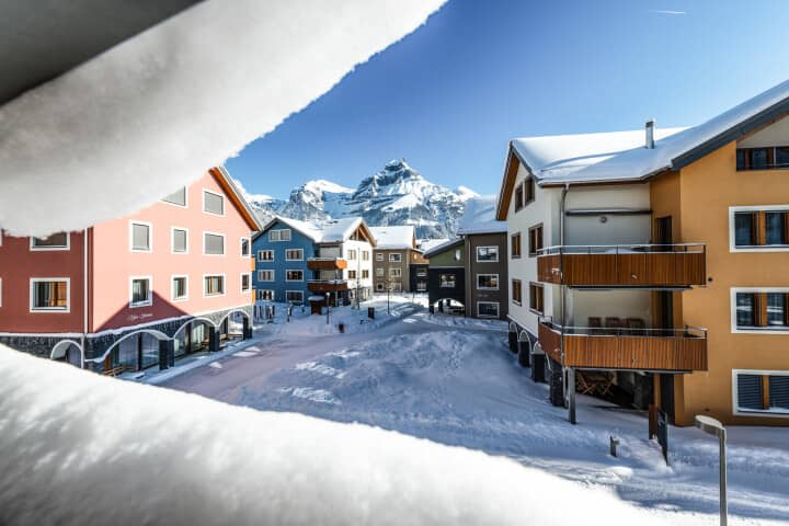 Balcony view of alpine village and mountain peak