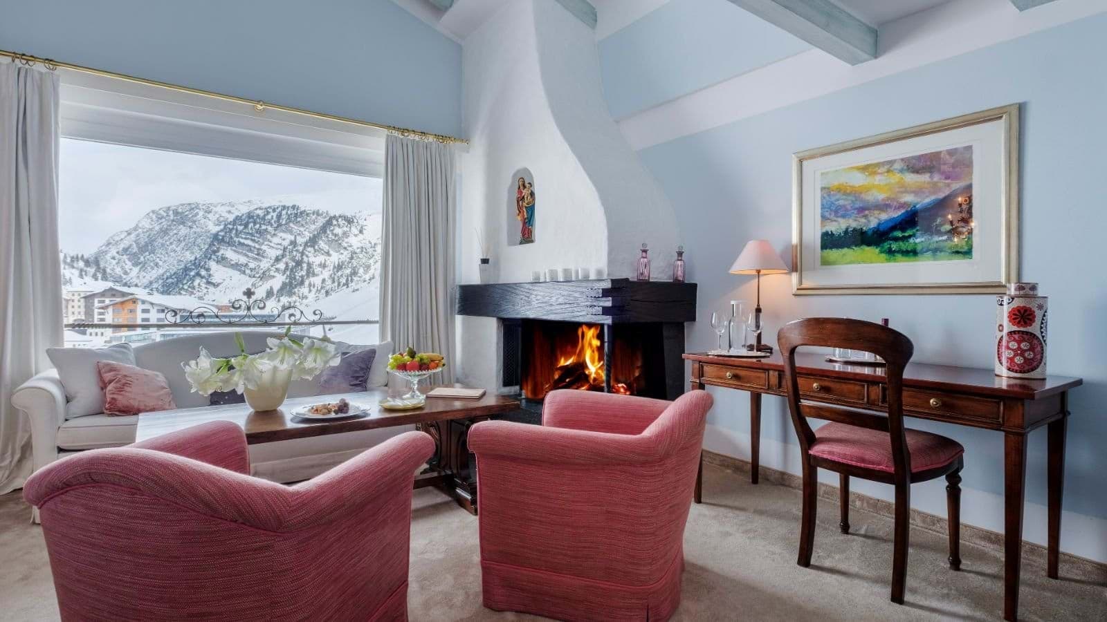 Sitting area with wood-burning fireplace, workspace, and mountain views