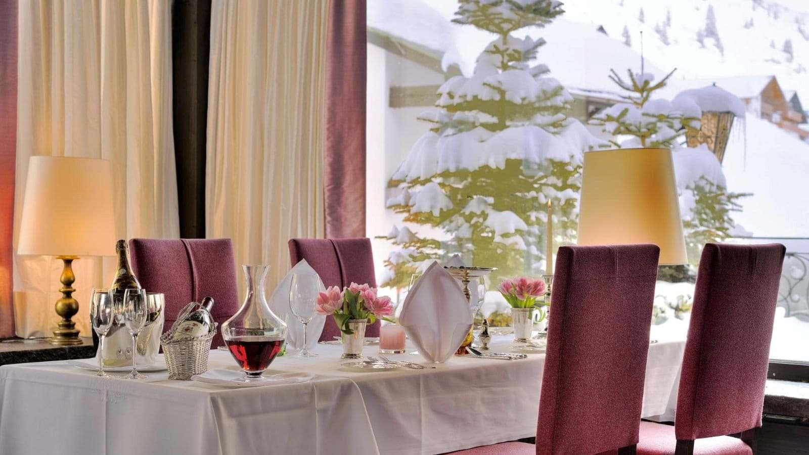Dining table set for 4 with snow-covered mountain views