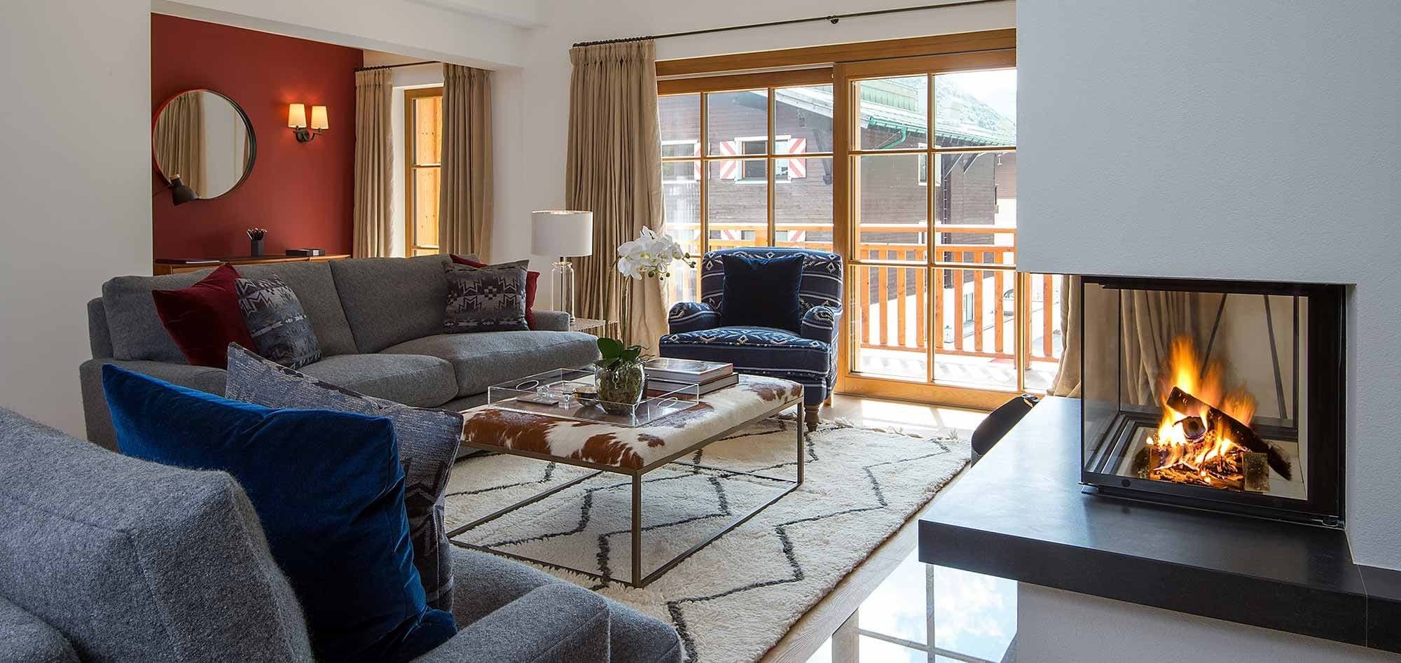 Living area with wood-burning fireplace and balcony access