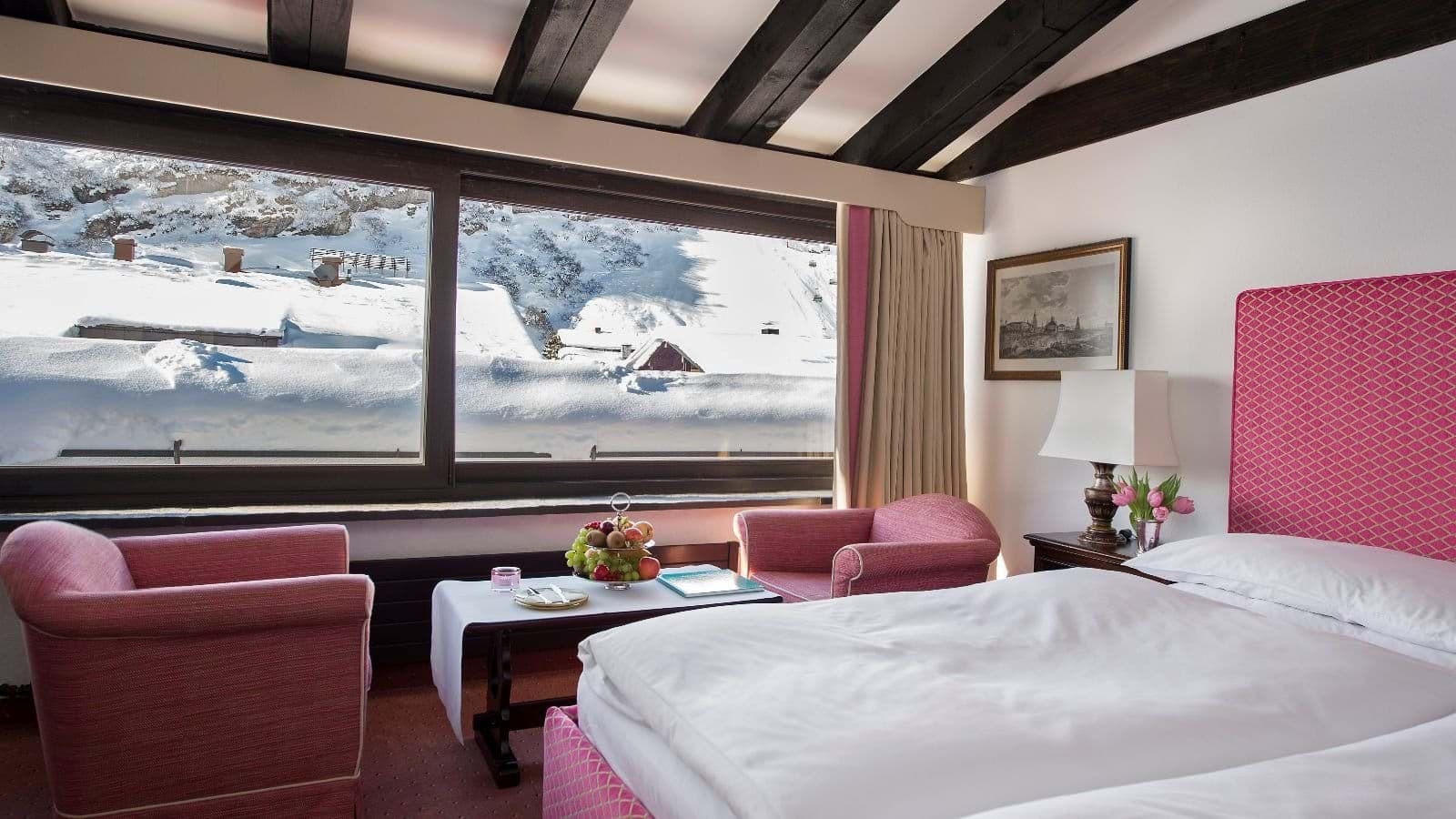 Guest bedroom with twin beds and panoramic alpine views