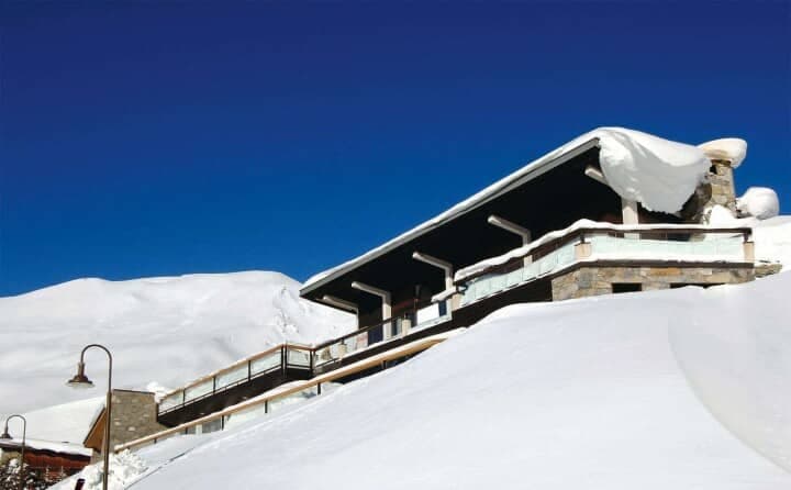 Ski-in/ski-out chalet with glass-walled balcony and mountain views