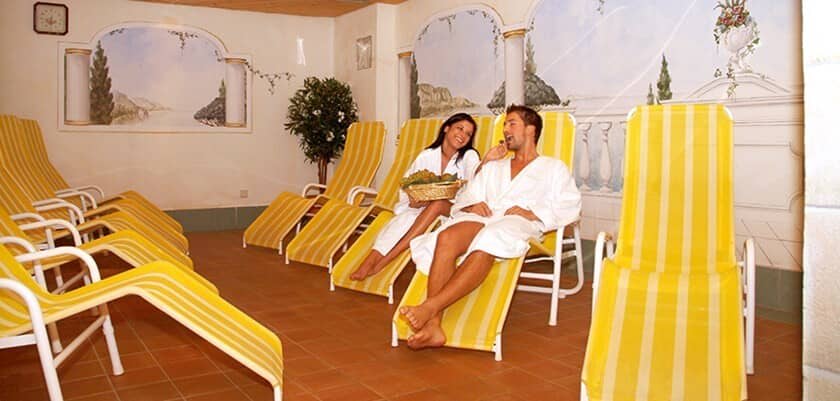 Indoor relaxation room with lounge chairs and Mediterranean wall murals