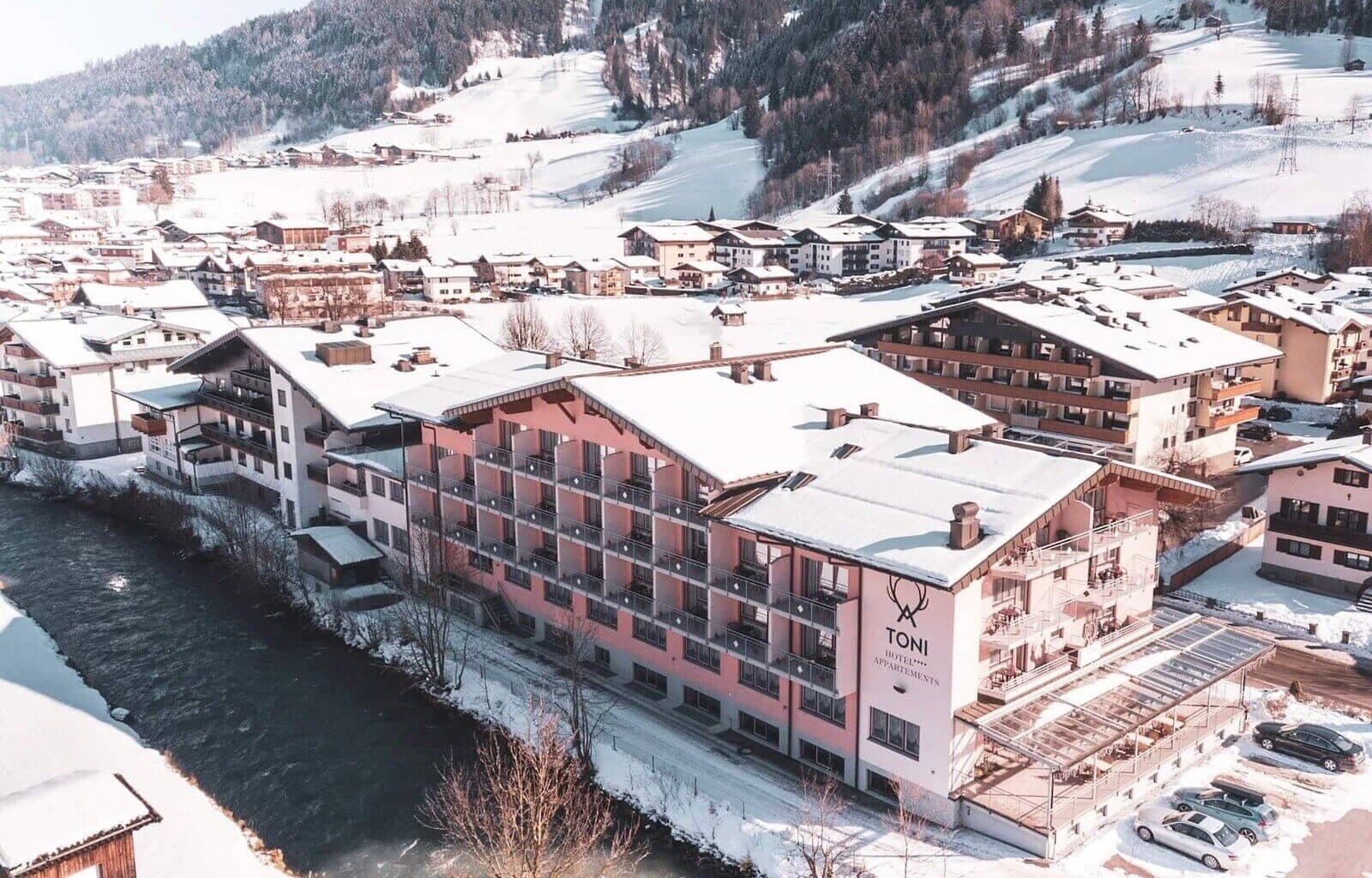 Riverside apartment exterior with private balconies and mountain views