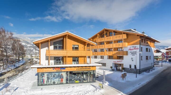 Chalet exterior featuring private balconies and on-site ski equipment shop
